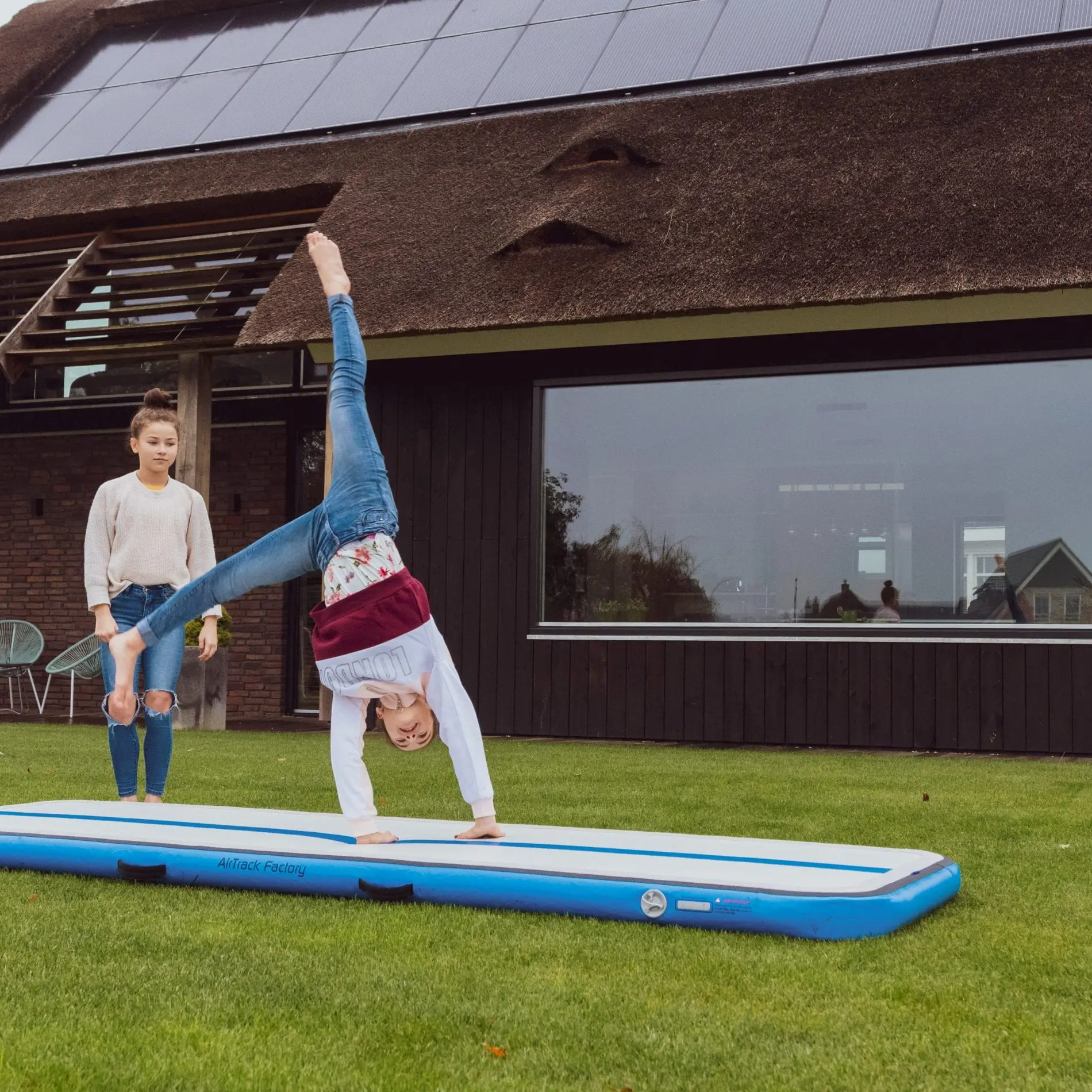 girls tumbling outside on AirTrack 3 meter AirFloor Home blue