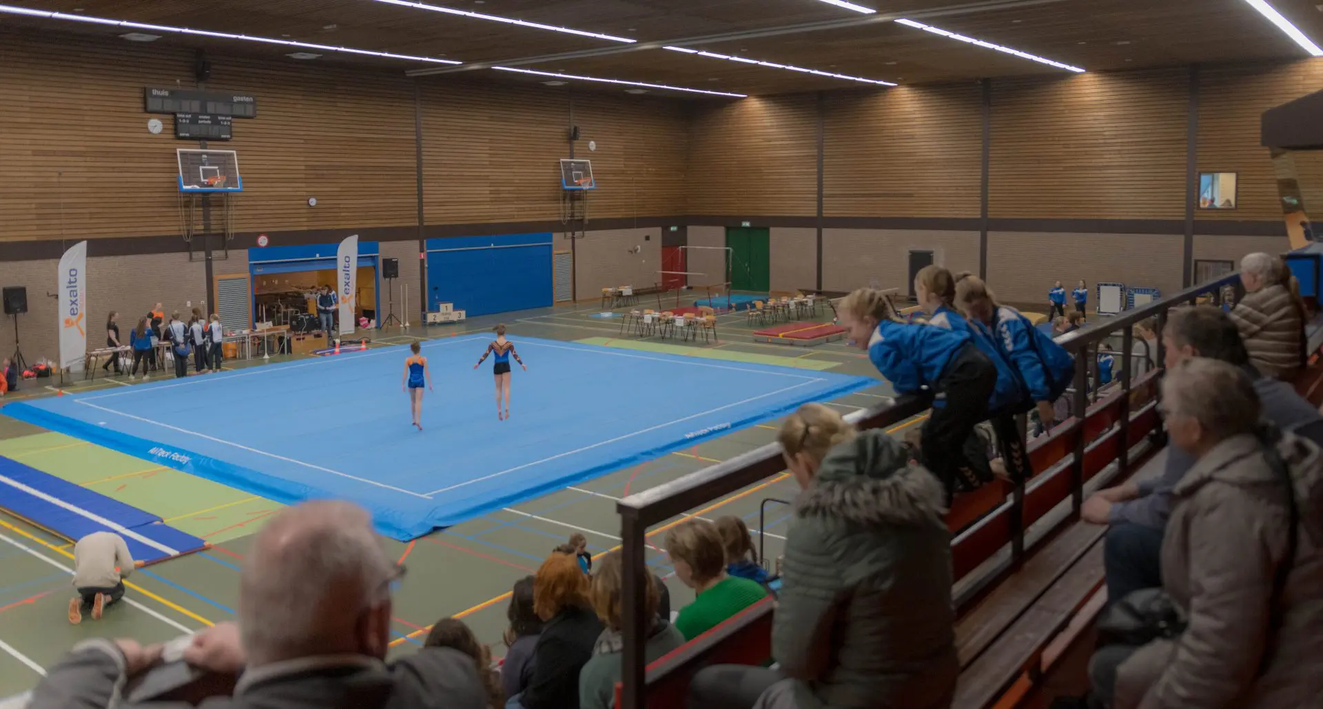 2 gymnasts performing during competition