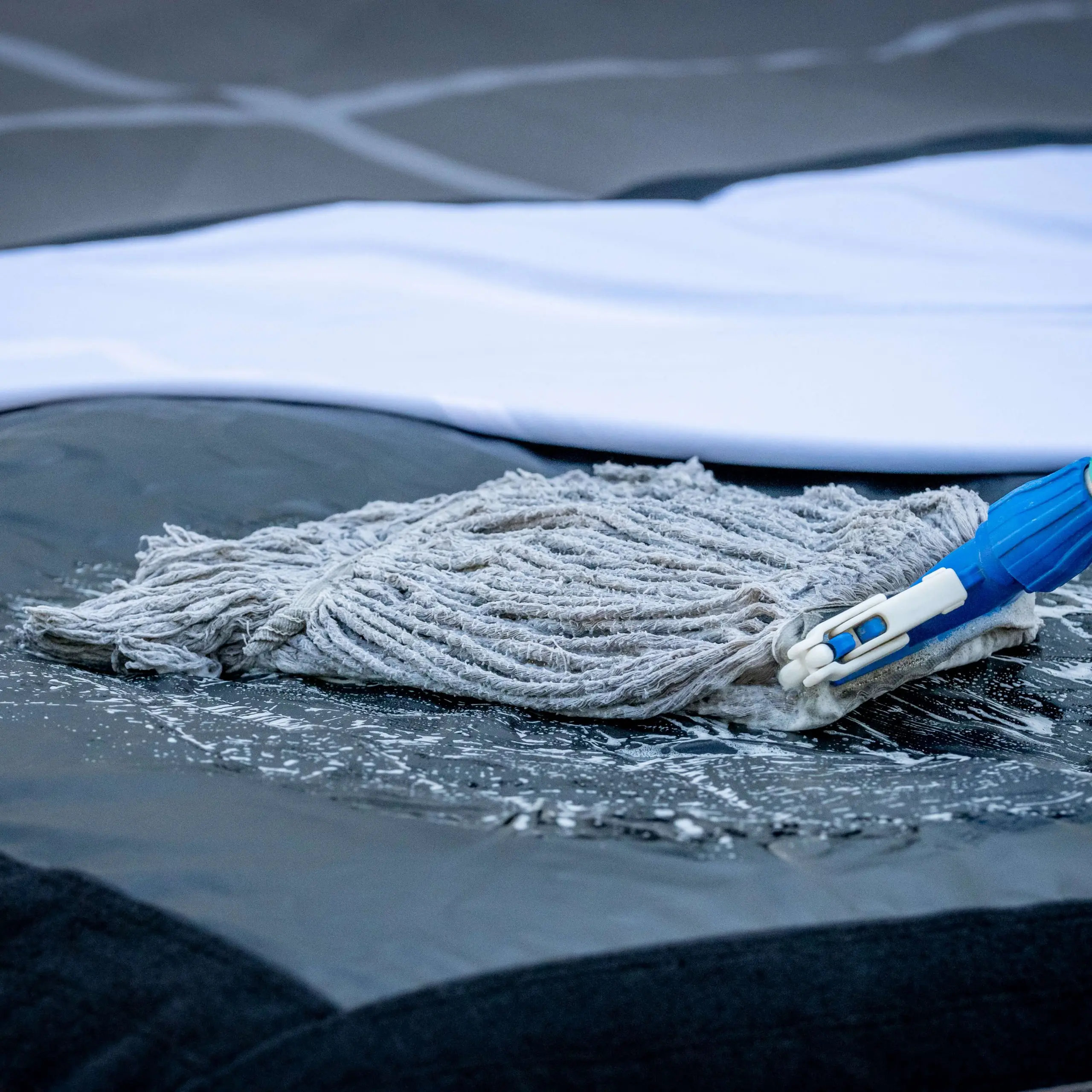 using a mop to clean the airbag